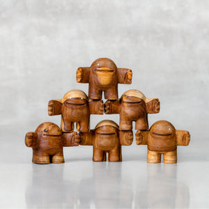 Tower of wooden toys with a friendly facial expression, standing upright with arms outstretched.