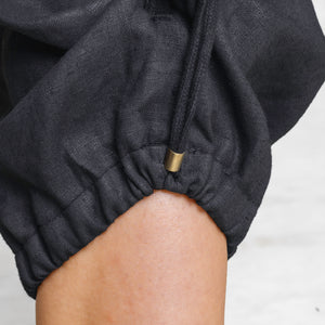 Close up of a drawstring ankle cuff on linen panys