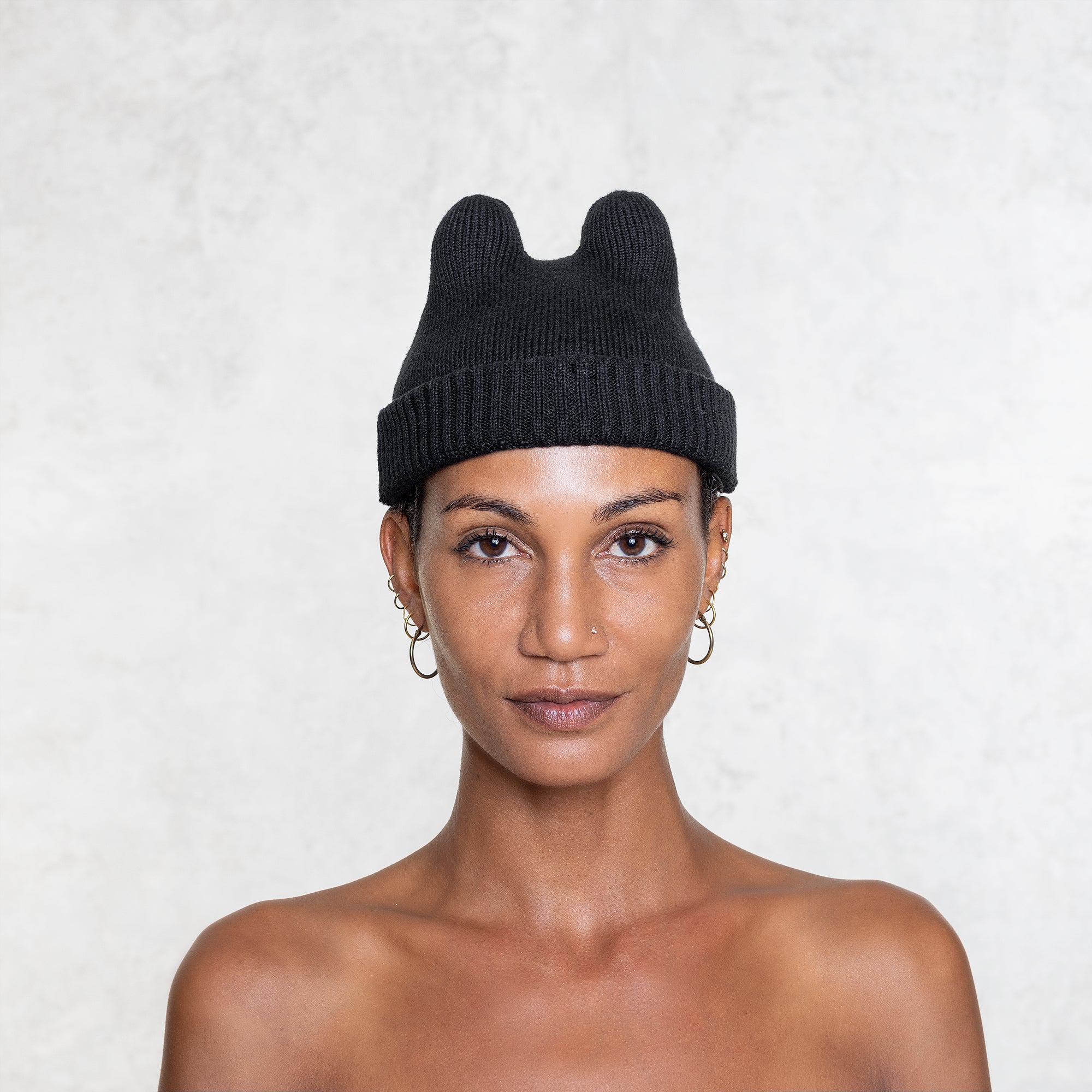 Cotton Elastic Black Bunny fisherman style Beanie on a woman from the shoulders up