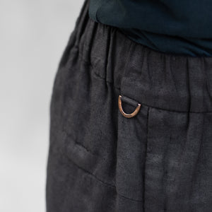 A detail of a D-ring on a pair of BLAMO linen pants 