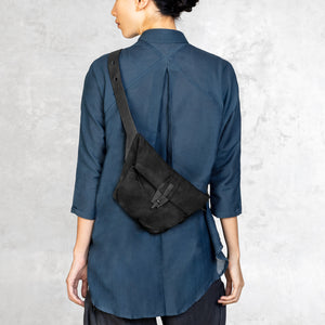 Leather waxed canvas Cross Body Bag worn by a woman on the back of her body 