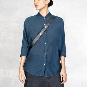 Leather Strap of a waxed canvas Cross Body Bag worn on a woman