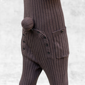 Brown Knit onesies with a buttoned pocket, buttoned up flap, and a tail