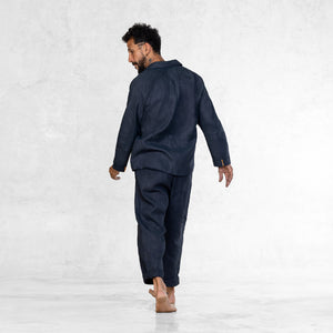 Man walking away barefoot in an Indigo Linen suit 