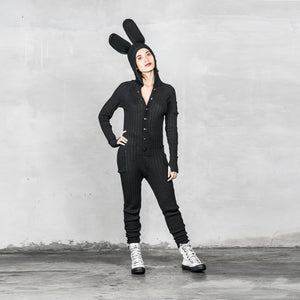 Model is wearing a Black Buttoned Bunny Jumpsuit for Adults standing against a light gray background