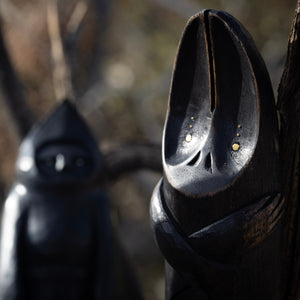 Close up on a wooden bat figurine with a blurred background