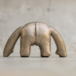 Metallic mesh sculpture of a creature on a neutral background