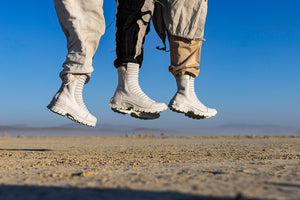 Three people jumping with images of their feet and lower legs showing white futuristic boots