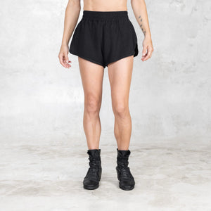 Front view of linen-cotton black boxer-style short with wide waistband, split hems, and relaxed athletic fit.