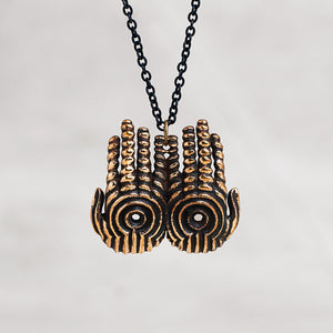 Copper hand pendant necklace charms with a black chain, shown against a neutral light gray background.