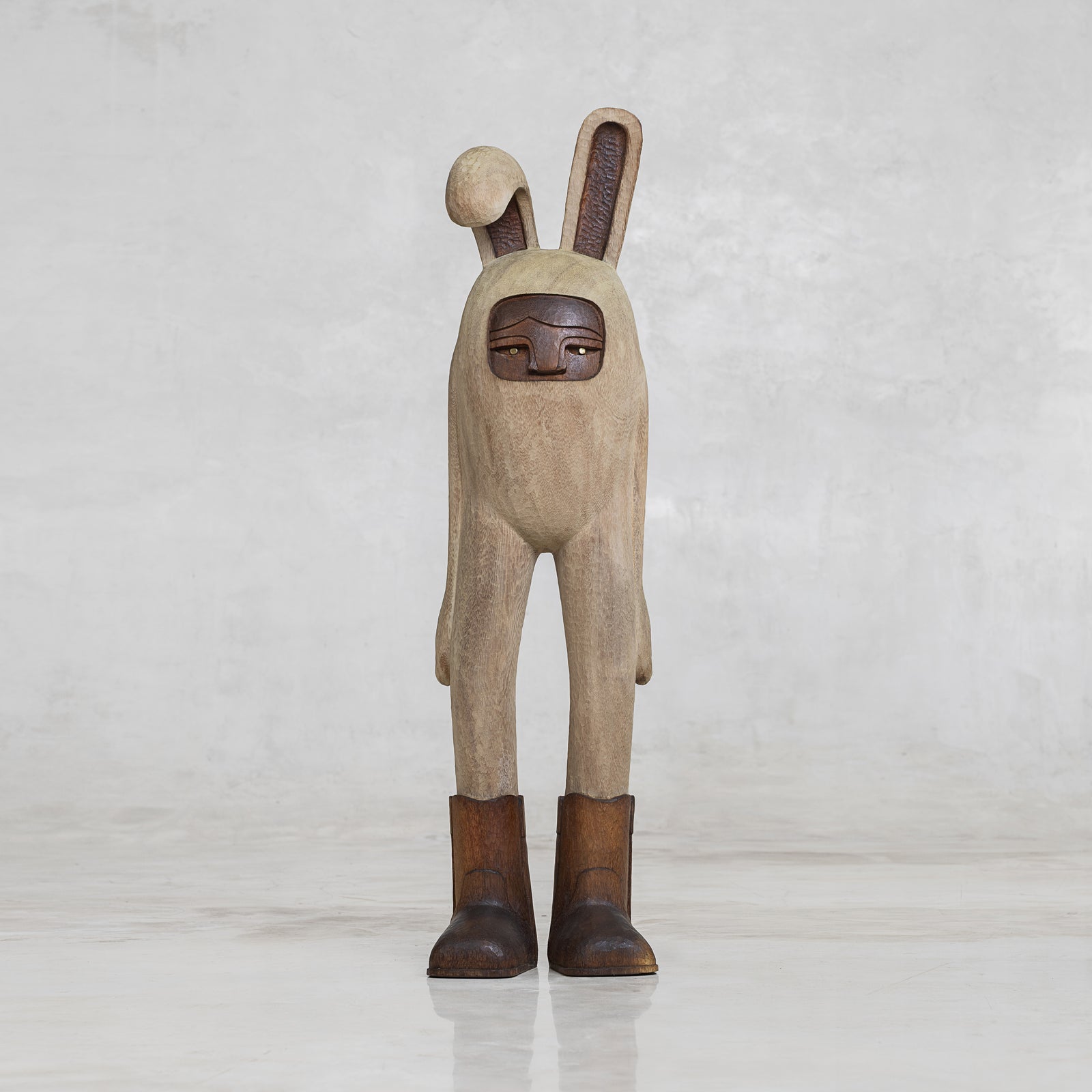 Wooden rabbit figurine with a neutral background