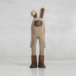 Wooden rabbit figurine with a neutral background