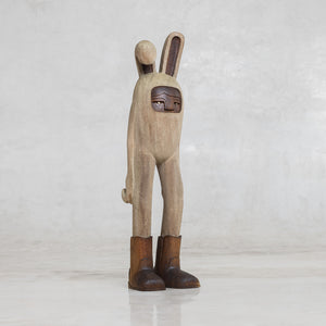 Wooden rabbit figurine with brown cowboy boots and with a neutral background