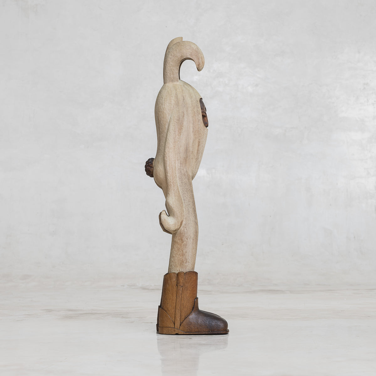 Wooden figure of a bunny rabbit with boots on a light gray background