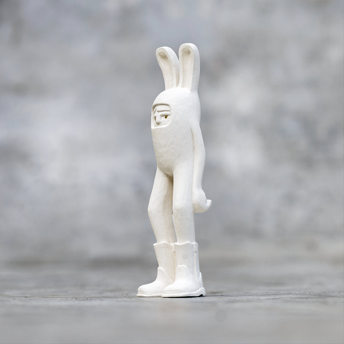 A 7"  Ceramic Blamo Rabbit Sculpture wearing cowboy boots