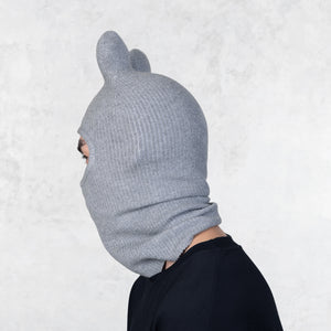 Person wearing a Blamo Bop gray knit balaclava against a light gray background