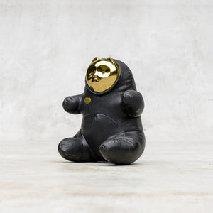 Quarter view of a black leather BLamo toy with brass face 