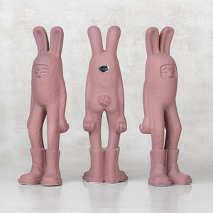 3 ceramic lavender bunny statuettes facing different directions against a light gray background