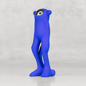 Blue monkey statuette with a silver face facing sideways against a light gray background