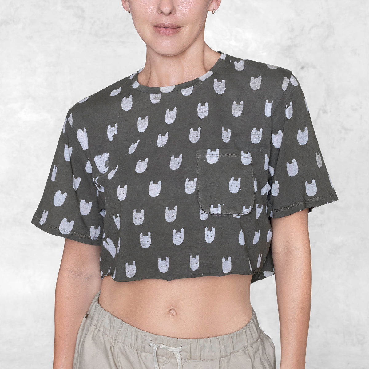 Woman from waist to chin wearing a cropped batik cotton shirt