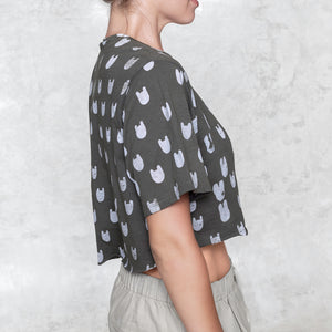 Woman from waist to chin wearing a cropped batik cotton shirt