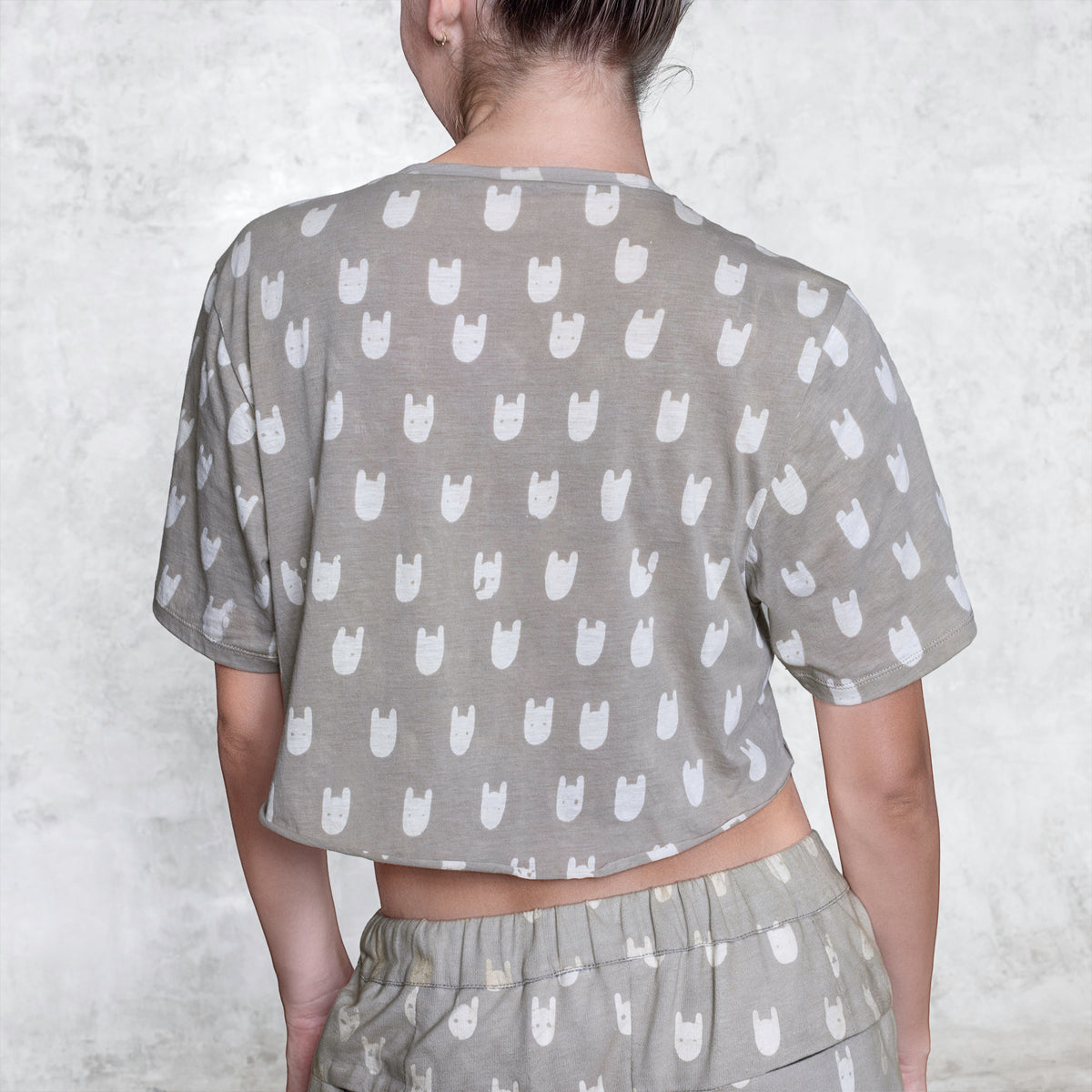 Woman from waist to chin wearing a cropped batik cotton shirt