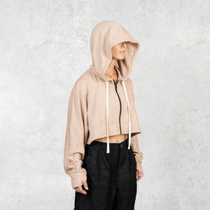 Model shown from the waist up wearing a fog colored cropped French terry Daydreamer Hoodie with a deep hood