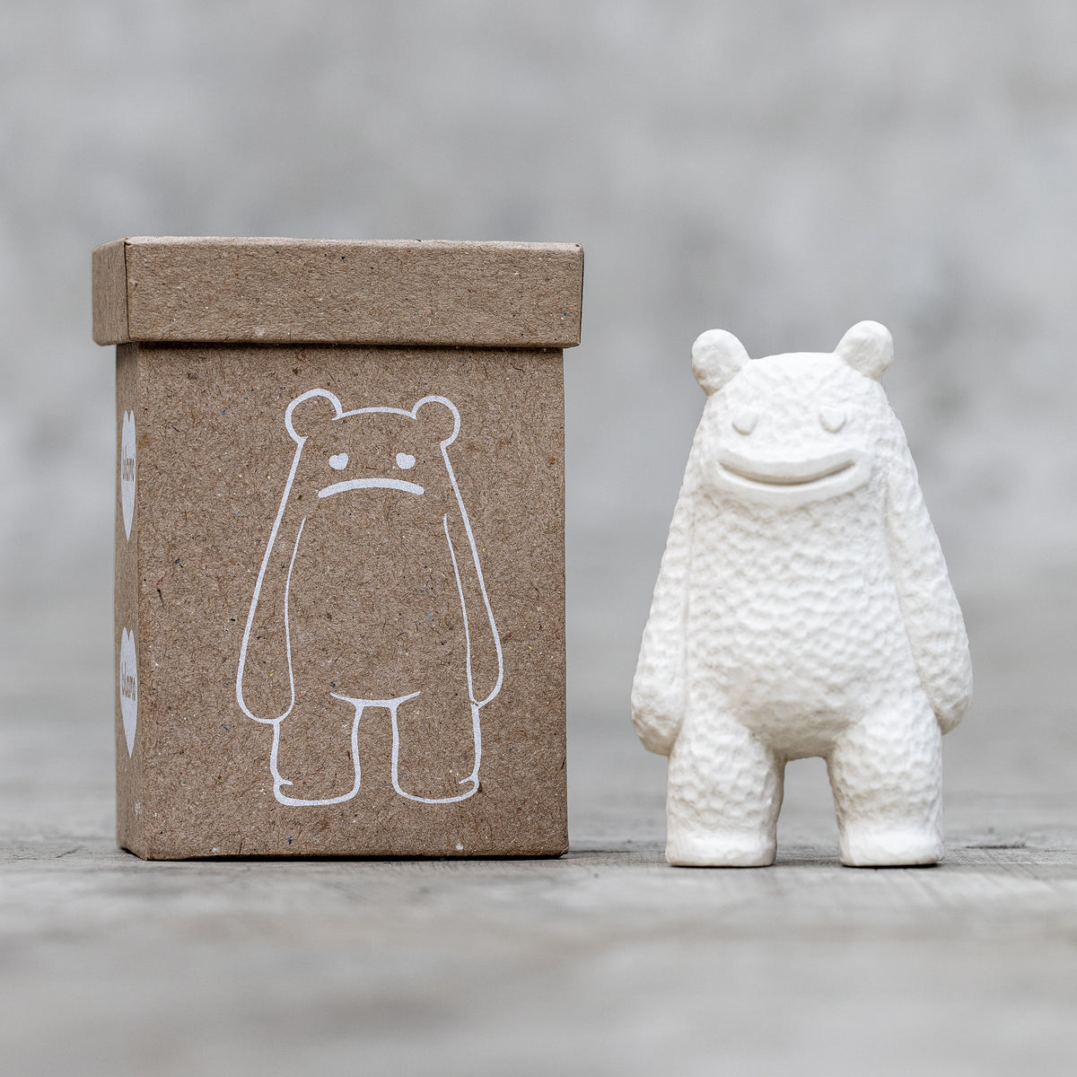 A small ceramic sculpture with a smile face