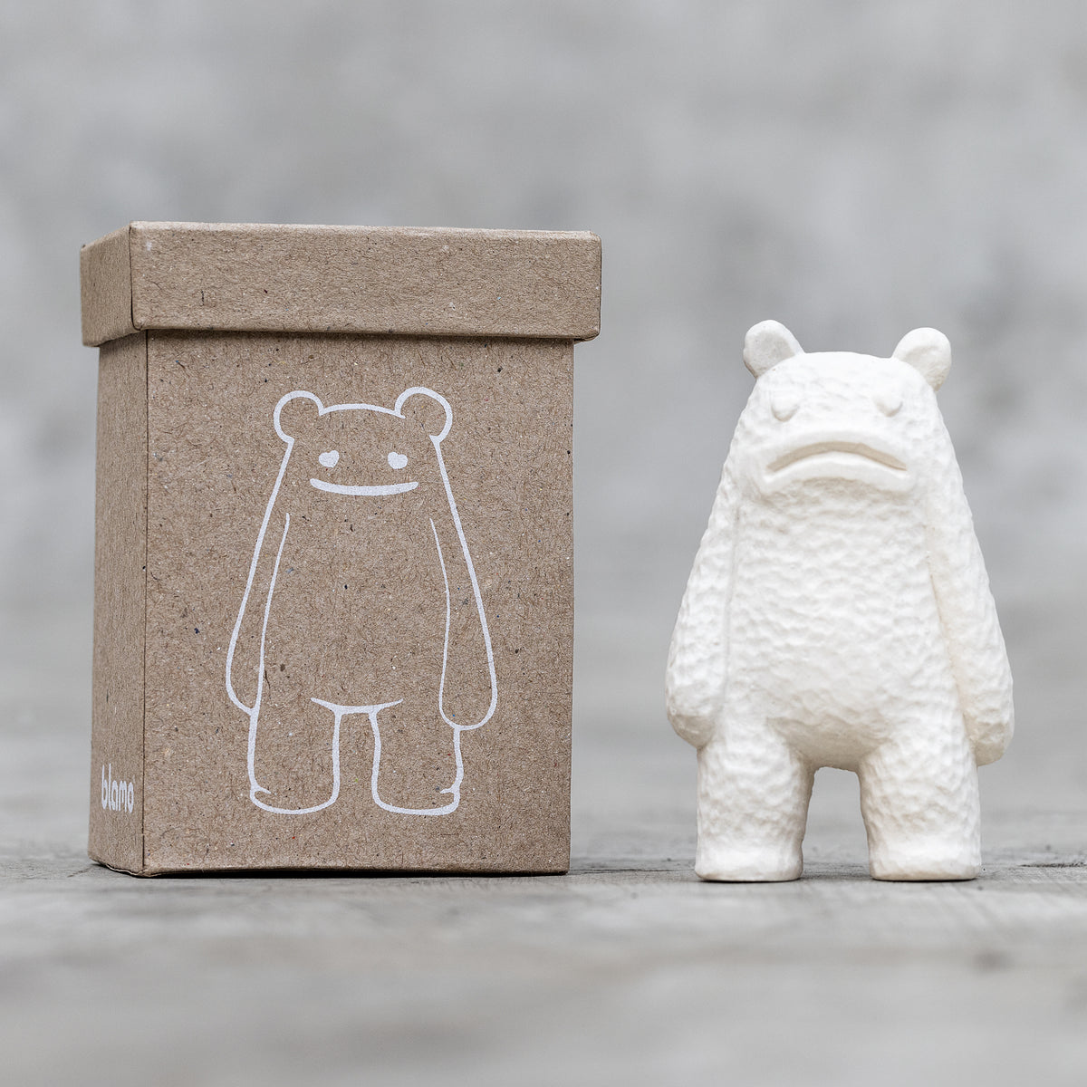 A small ceramic sculpture with a sad face