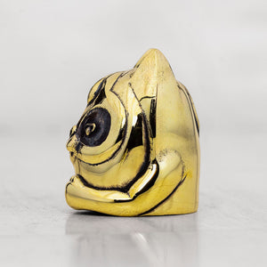 Gold brass animal-shaped object on a white background