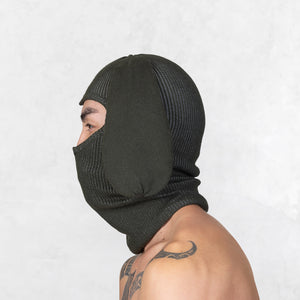 Person wearing a Blamo Flop Dark Olive knit balaclava on a white background