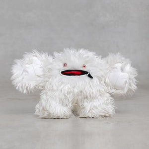 White fluffy creature with pink eyes and a black and red mouth on a gray background