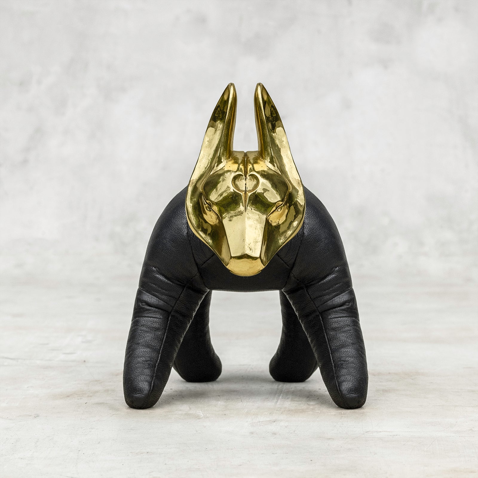 A BLAMO brass and leather wolfdog sculpture