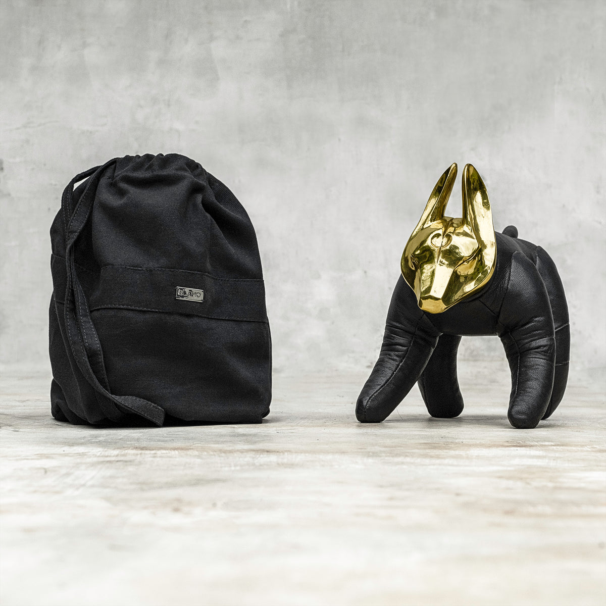 A BLAMO brass and leather wolfdog sculpture