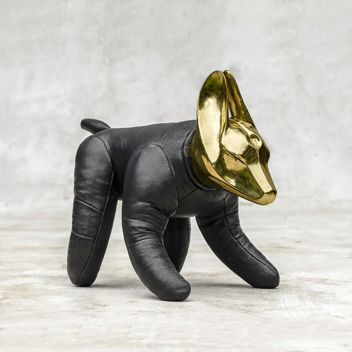 A BLAMO brass and leather wolfdog sculpture