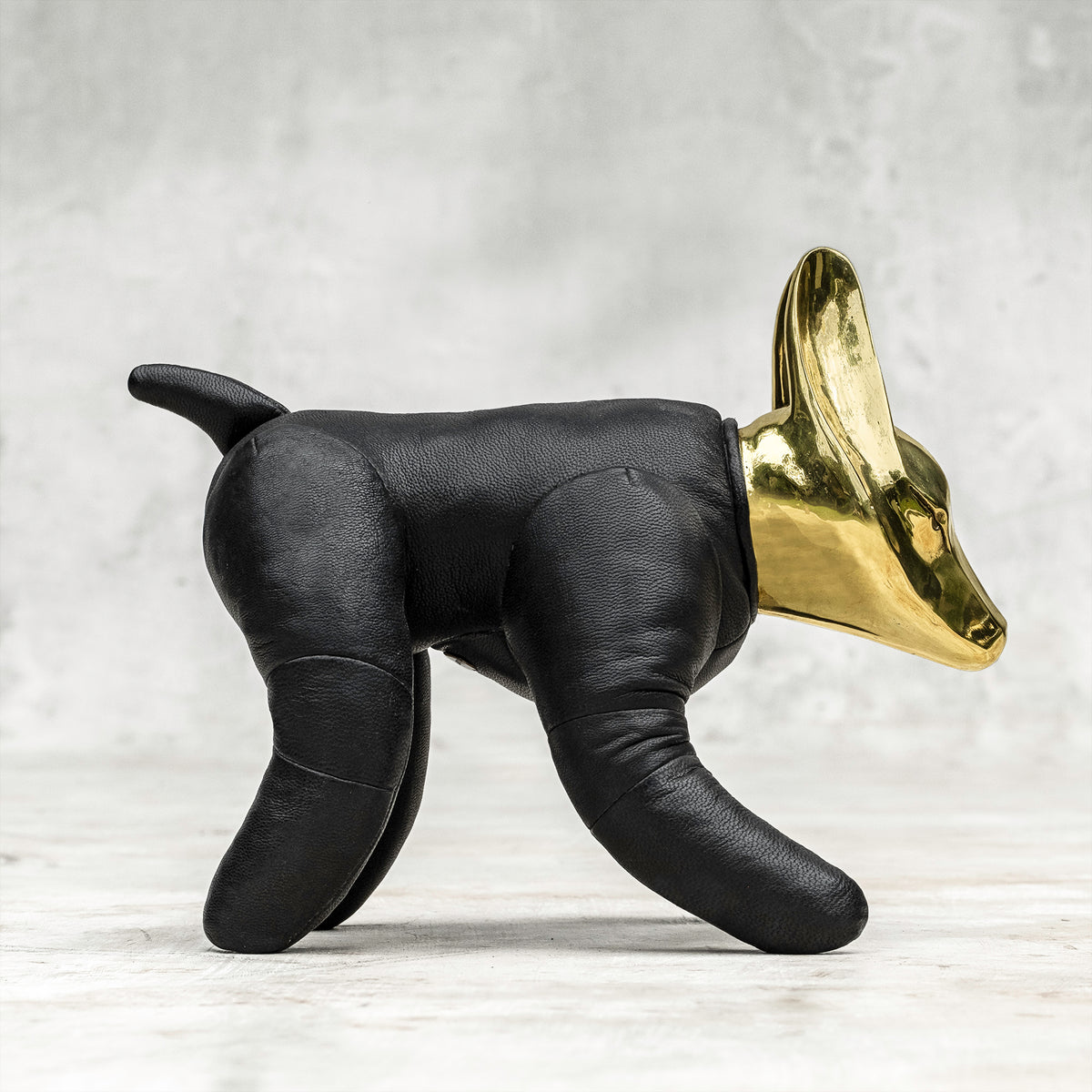 A BLAMO brass and leather wolfdog sculpture