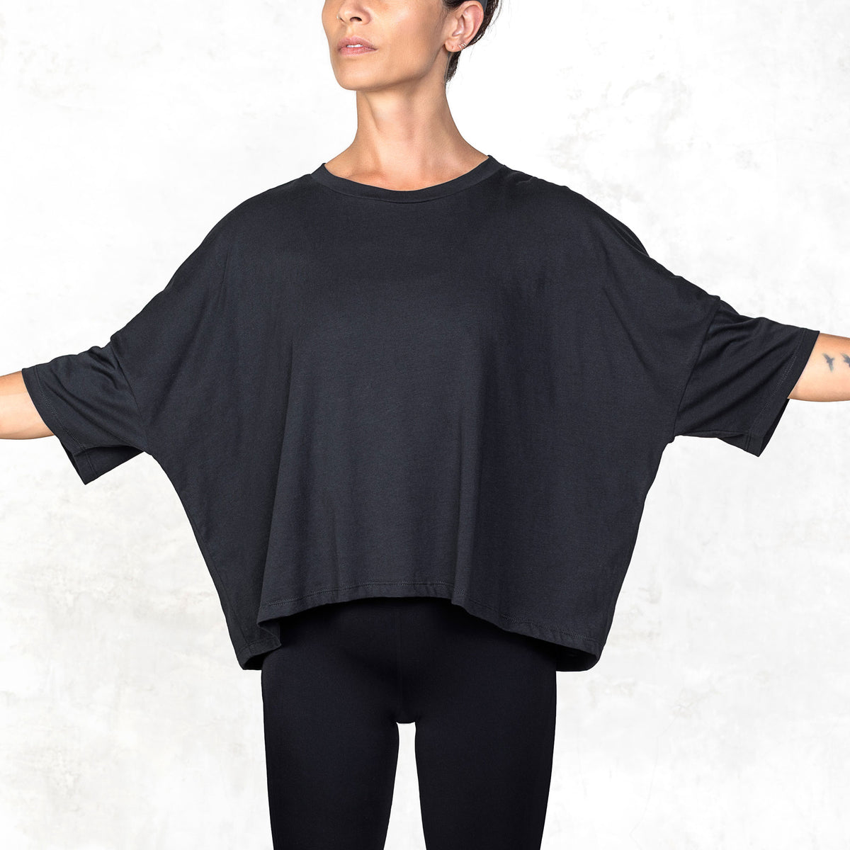 Waist-up view of model wearing the Katana cropped tee in Supima cotton with boxy relaxed fit, front facing.