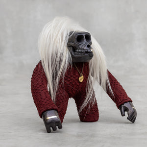 a red python leather ape sculpture with long white goat hair 