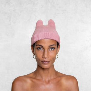 Woman from the chest up wearing Blamo Pink Bunny Beanie