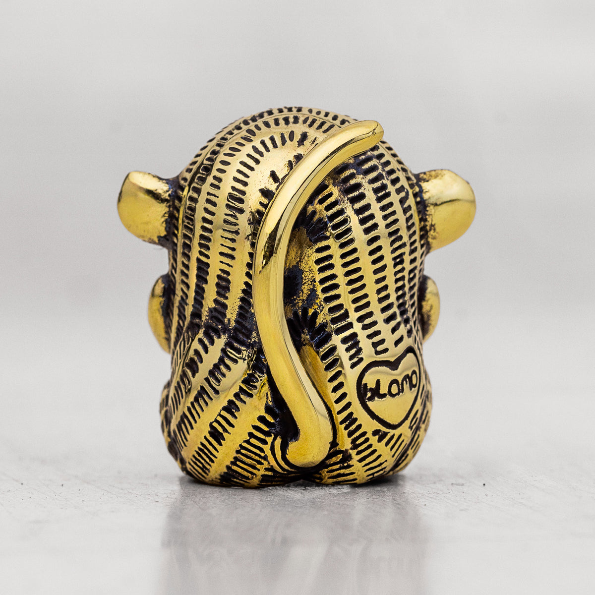 Gold and black brass Monkey figurine item with 'Blamo' branding on a gray background