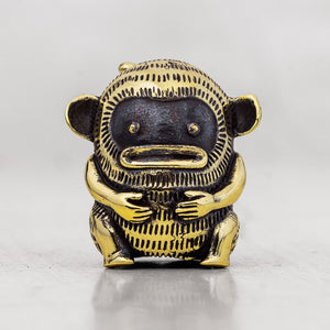 Gold and black monkey finger puppet figurine on a white background