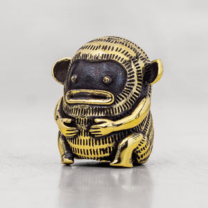 Brass monkey figurine on a white background