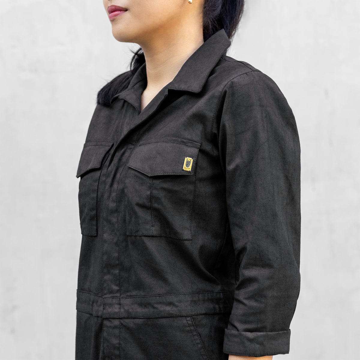 Close up of the chest pockets of a one piece black walnut mechanic style BLAMO jumpsuit 