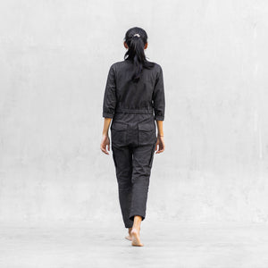 Woman walking from behind in a one piece black walnut mechanic style BLAMO jumpsuit 