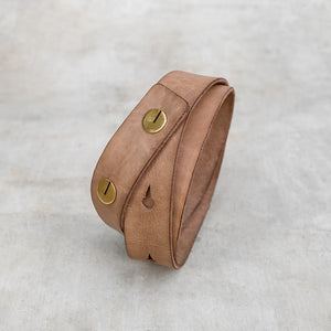 Natural colored leather strap belt with brass buttons