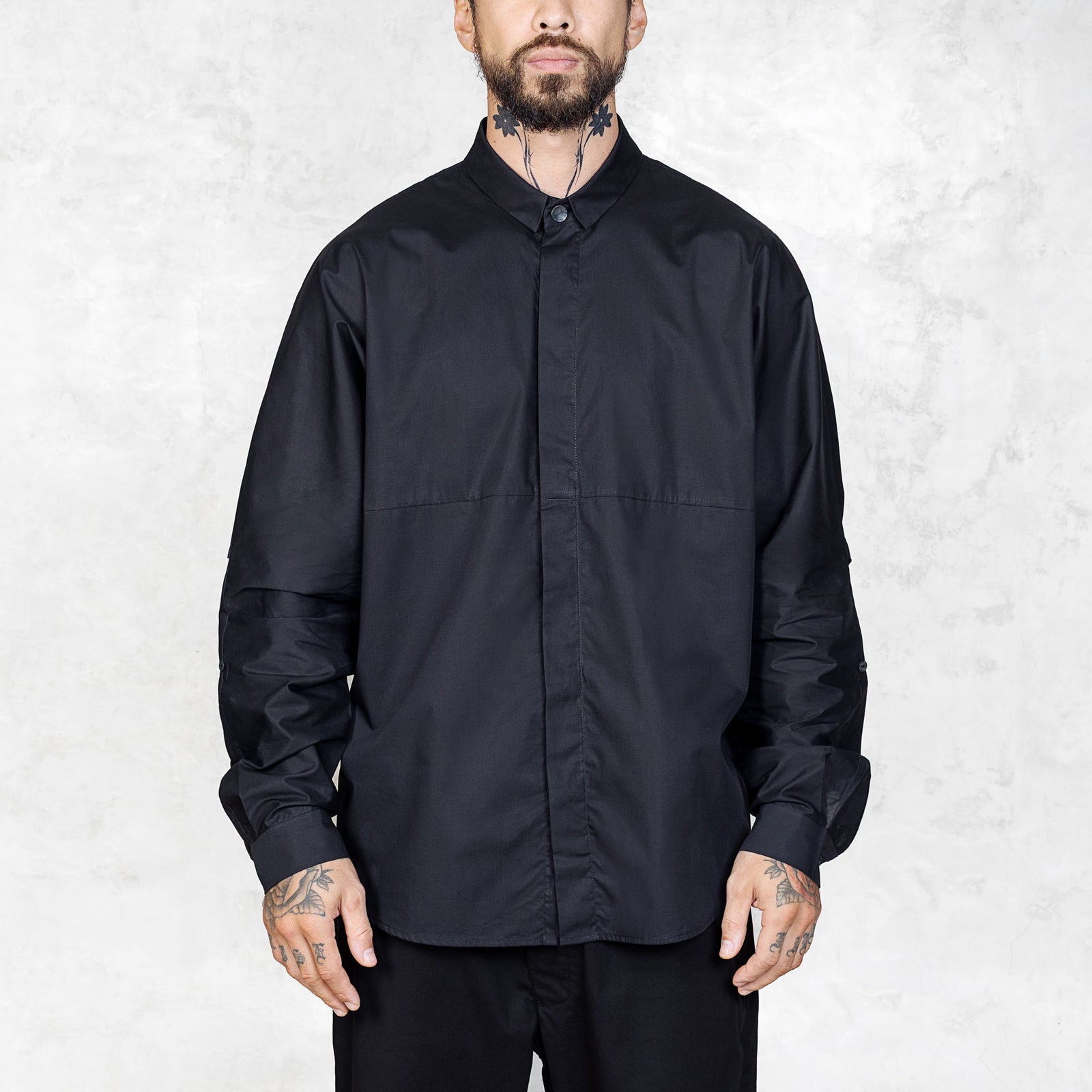 Person wearing a black shirt against a white background