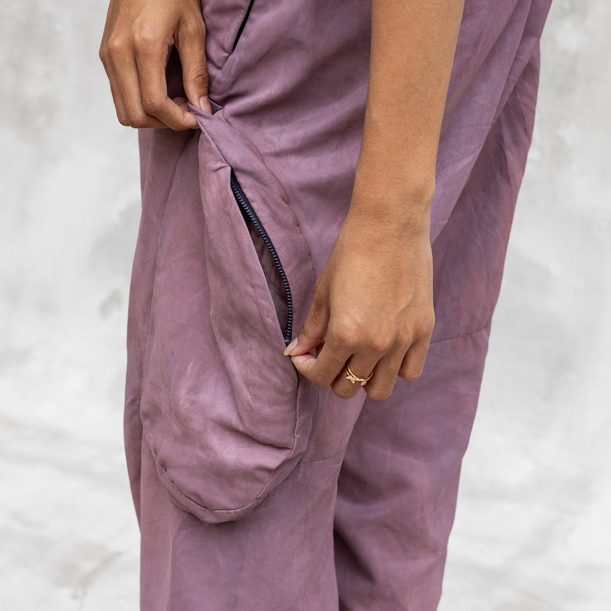 A close up of th eside bellow cargo pocket on a pair of BLAMO silk pants