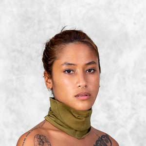 Woman from neck up wearing an Olive face buff mask 