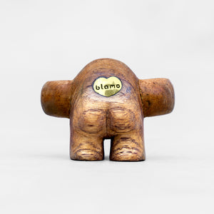 Hand Carved Teak Wood Art Toy with arms extended like a HUG and Rose sapphire eyes