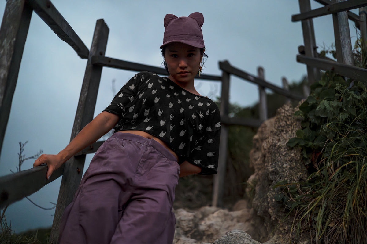 A woman with a BLAMO pink silk cap with ears